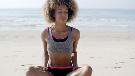 fit woman sits on the beach