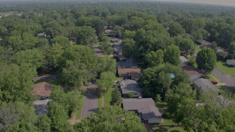 aerial track left over suburban ranch style homes in suburbs