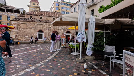 bustling outdoor cafe and historic building in an athens city square