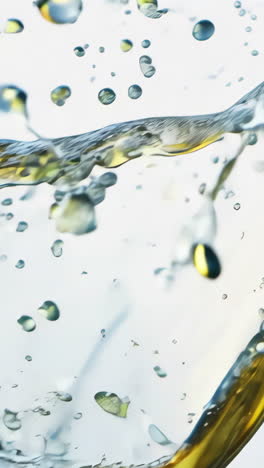 clear liquid splashes in mid-air on a light background. water droplets and liquid gracefully leap in the air, creating an artistic display of motion against a soft backdrop. vertical video