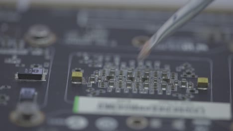 cleaning a motherboard and its components with a small paint brush - selective focus