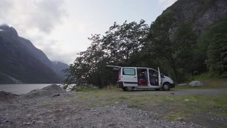 Camper-Van-Parked-With-Doors-Open-Near-Lake-In-Katthammaren,-Norway