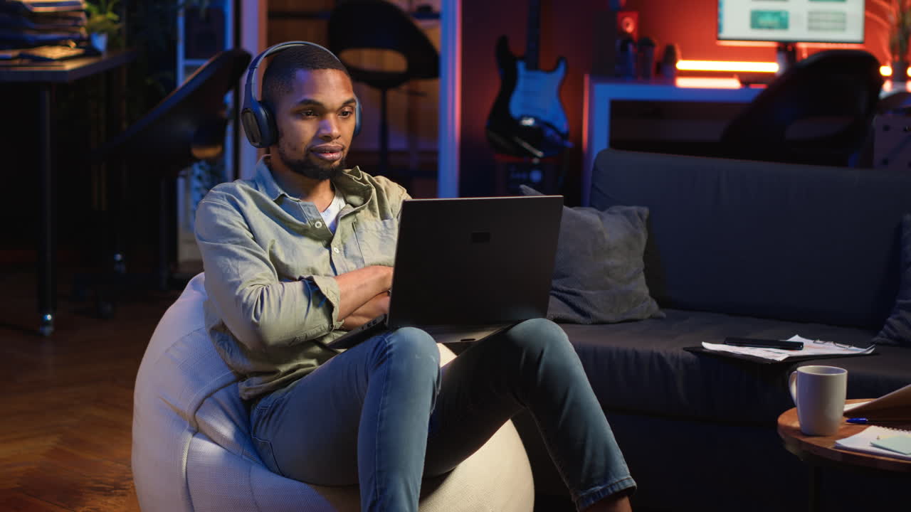 Vertical Video Black person listening to focus music on headphones to finish tasks