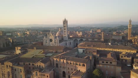 aerial cityscape view of siena city on tuscany italy with cathedral dome at sunset, characteristic italian village in medieval gothic style