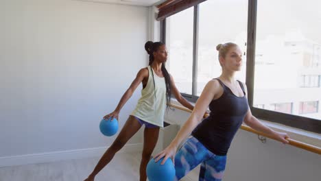 group of women exercising on the barre 4k