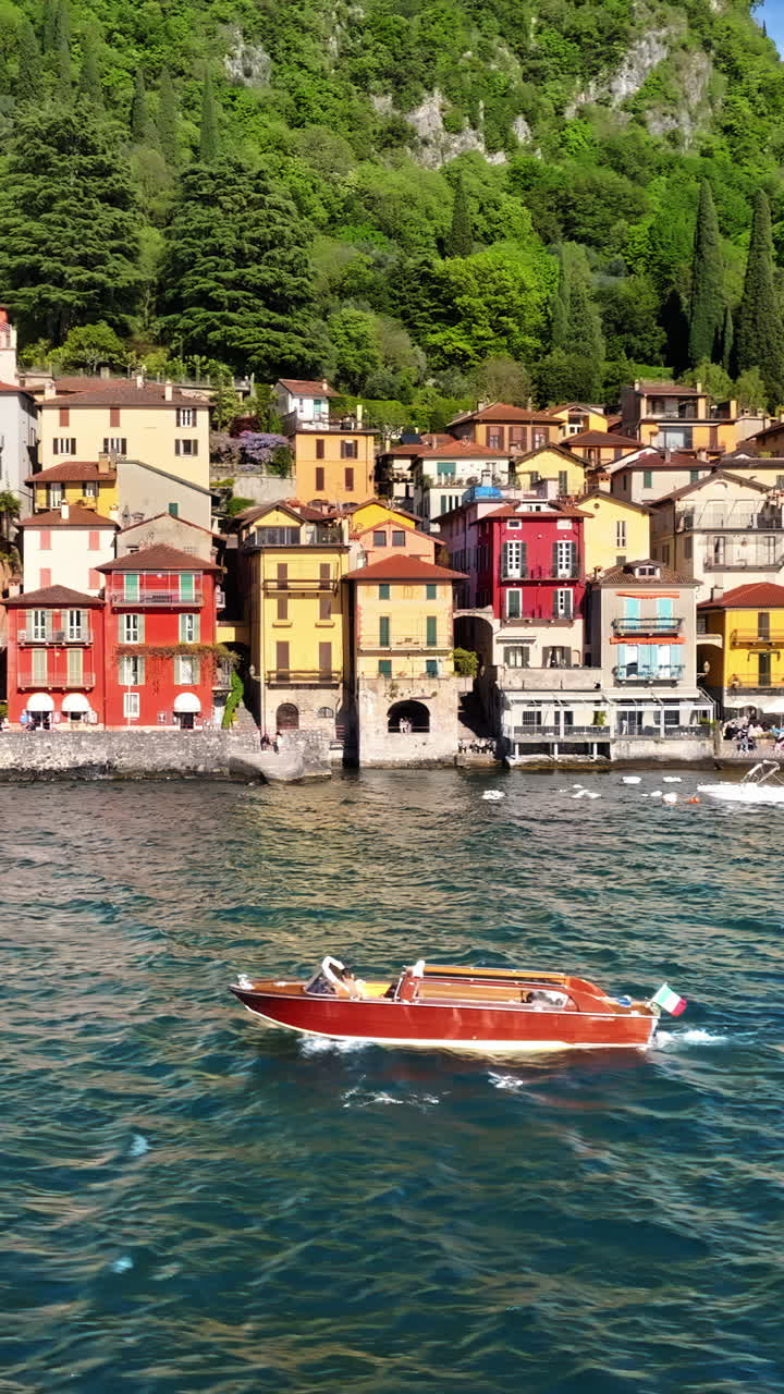 Aerial drone view of boats on the shore of Varenna, Italy near Lake Como. Vertical