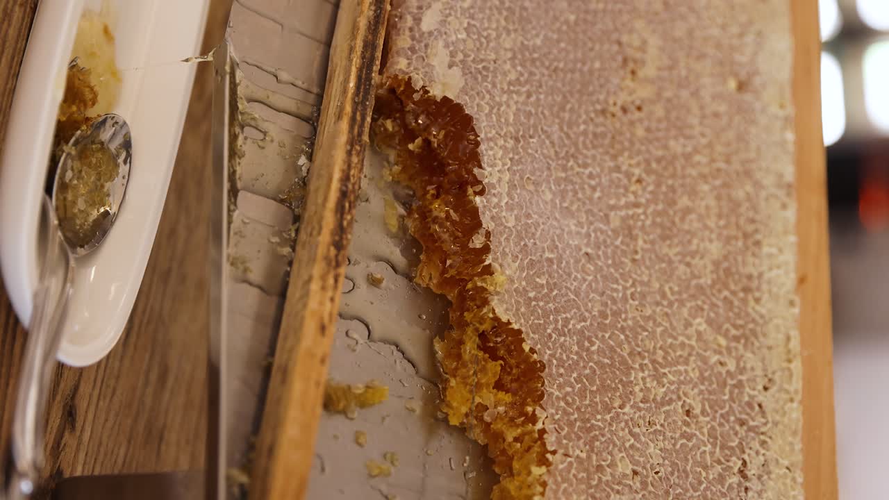 Favo di miele su un telaio di legno, preso e mangiato fresco dall'alveare