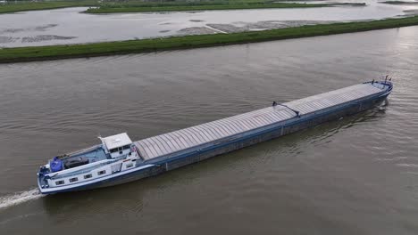 cargo ship cruising on river in alblasserdam, netherlands