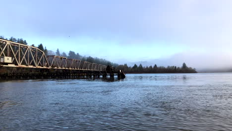 large steel pivot railroad bridge spanning the umpqua river bay near reedsport oregon