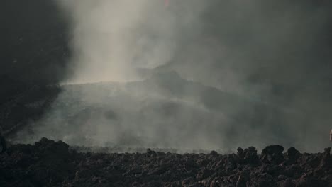 smoke covering a lava field of the pacaya volcano in guatemala - wide shot