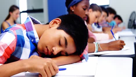 tired student sleeping in classroom