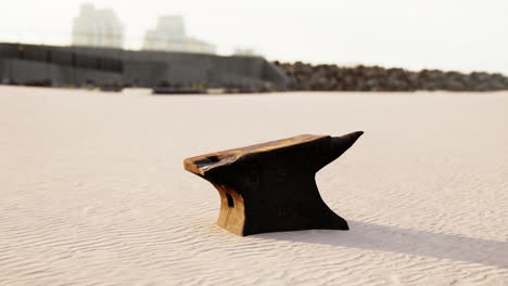 old anvil on a sandy beach