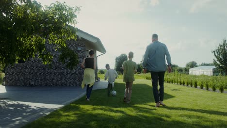 family playing soccer in the backyard