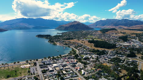 Aerial-flying-forward-over-Wanaka-in-sunny-day,-New-Zealand