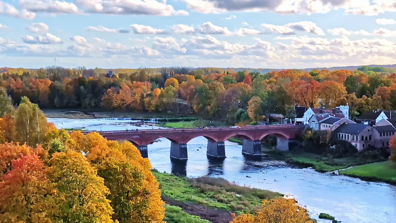Kuldiga old brick bridge over Venta river in Latvia, autumn countryside