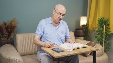 the old man is breaking up with his wife on the phone and is upset.