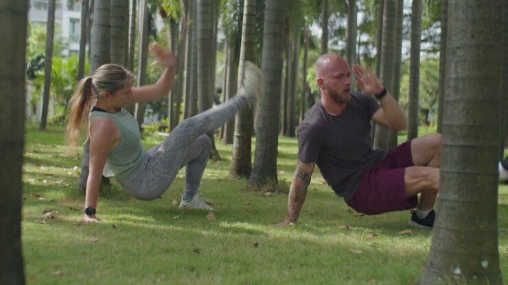 Couple Having Bodyweight Workout Together Outdoors