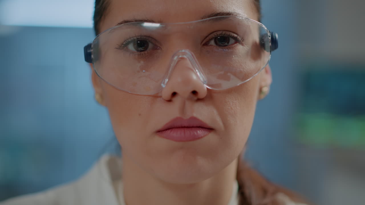 Chemist woman looking at camera in science laboratory