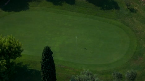 Aerial-Overhead-View-Of-Green-On-Golf-Course-With-Flag