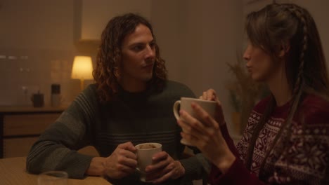 couple enjoying hot drinks at home