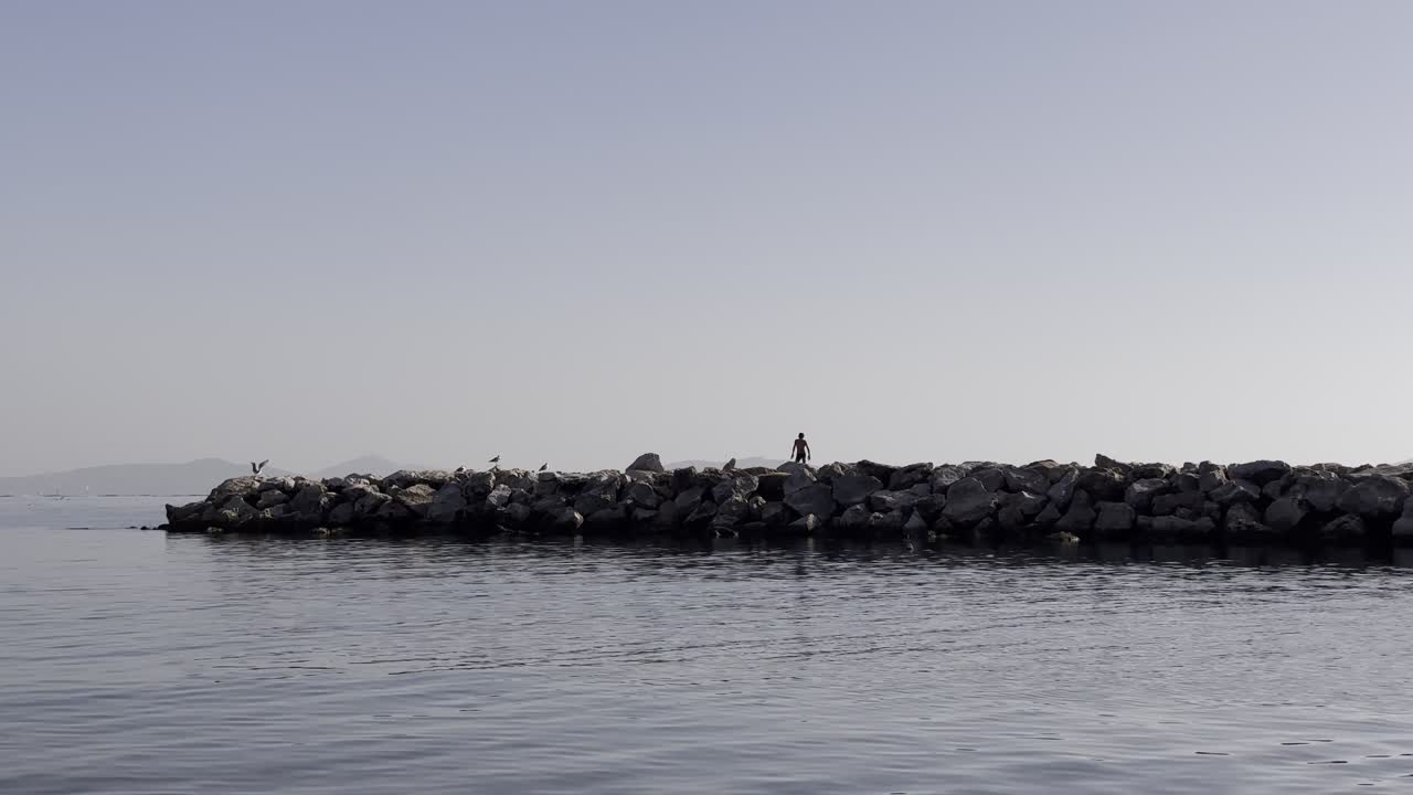 child running and playing on the pier in the sea