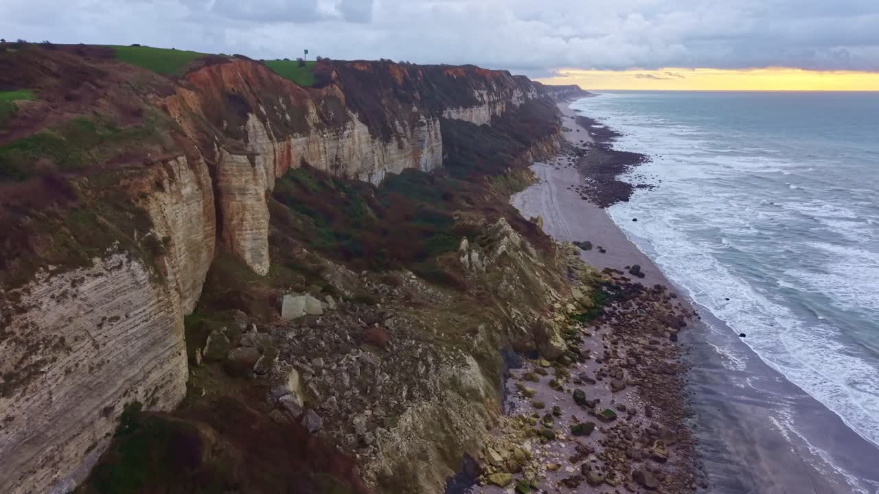 Drone flying along the coastline, cliffs , on the Alabaster coast, Saint-Jouin-Bruneval beach, Normandy in France. Aerial ascending forward