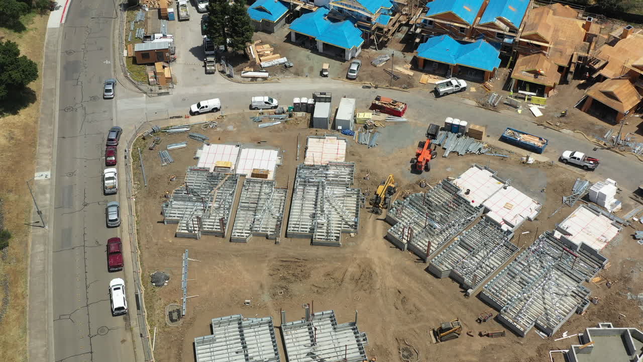 Aerial view with slow rotation of construction workers building townhomes after the 2017 Tubbs Fire destroyed large areas of Santa Rosa, California