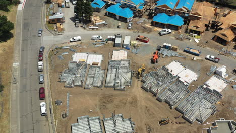aerial view with slow rotation of construction workers building townhomes after the 2017 tubbs fire destroyed large areas of santa rosa, california
