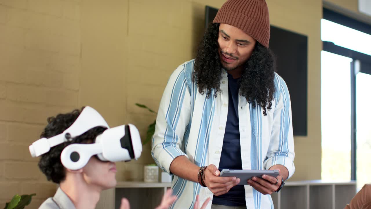 After tablet tapping, Diverse coworkers adjusting white VR headset for demo in office, copy space