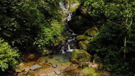 4k aerial fly over shot over a bridge next to next to a waterfall in the forests of khasi hills, cheerapunji, meghalaya, india