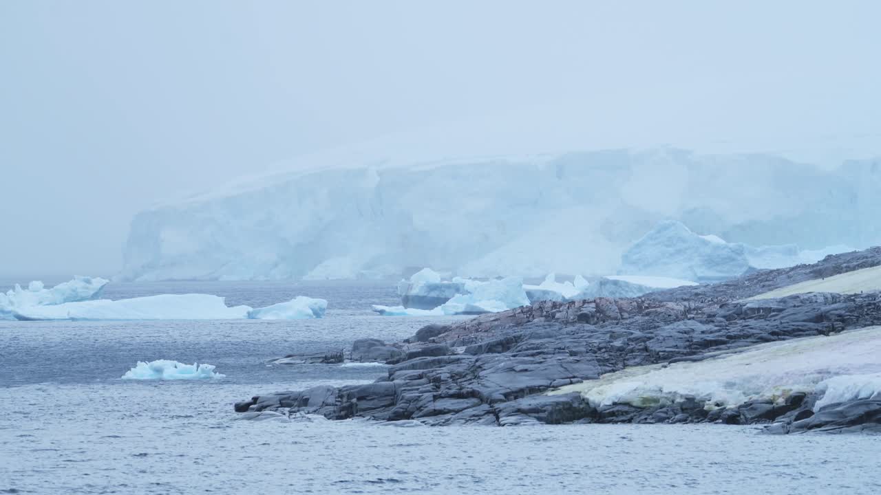 Icy Antarctic Landscape with Icebergs and Glacier