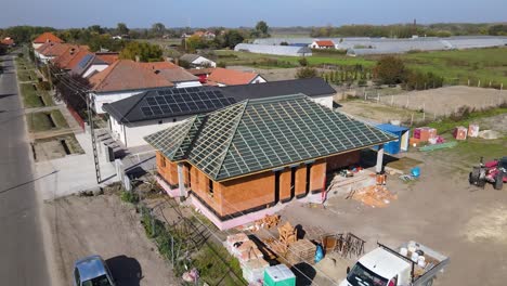 new house under construction with brick walls and timber roof framework with battens, drone view