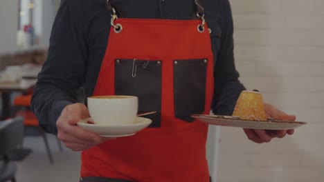 waiter serving coffee and dessert