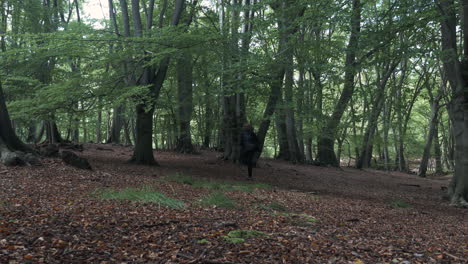 scared man running along woodland forest