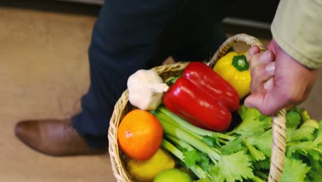 man holding fresh vegetables in basket