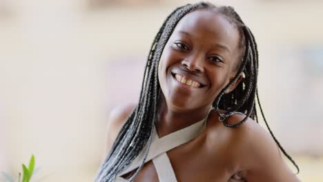 joyful black woman with braids laughing and smiling