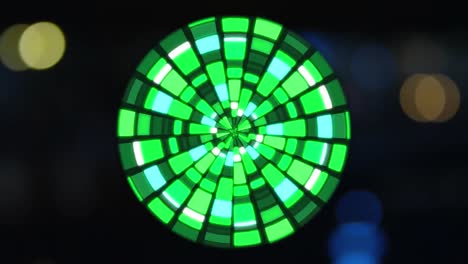 Animation-of-globe-made-of-green-lights-rotating-over-blurred-night-cityscape