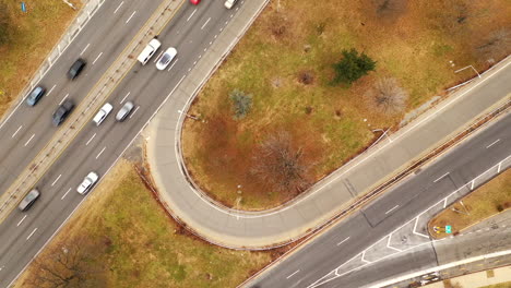 a time lapse directly above a belt parkway entrance ramp, it is a bird's eye view which was taken on a busy day in brooklyn, new york