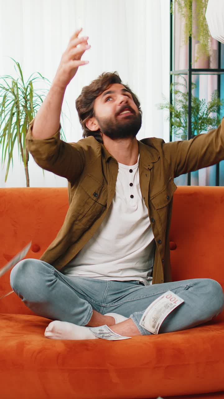 Money cash dollar rain falling on man celebrating success winning good news lottery jackpot luck