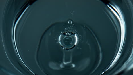 liquid droplet falling water top view. closeup refreshing drink waving rippling