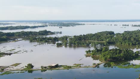 aerial view of floodwaters covering land in rural sylhet, bangladesh