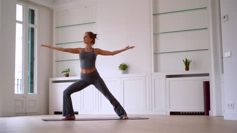 flexible woman doing yoga on mat at home