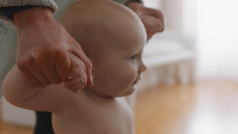 happy baby learning to walk toddler taking first steps with mother helping infant teaching child at home