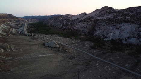 A-road-through-a-valley-embedded-in-the-twilight,-bird's-eye-view-of-cottonwood-canyon-road-in-vermillion-cliffs-Utah