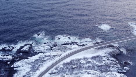 winter surrounds djupfjordbrua bridge, rhythmic ripples on ocean surface