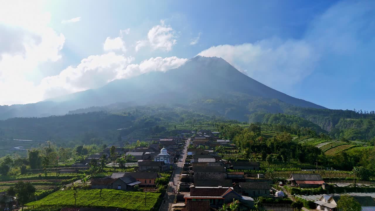 Cozy local village of Indonesia with Merapi volcano in background, aerial drone view