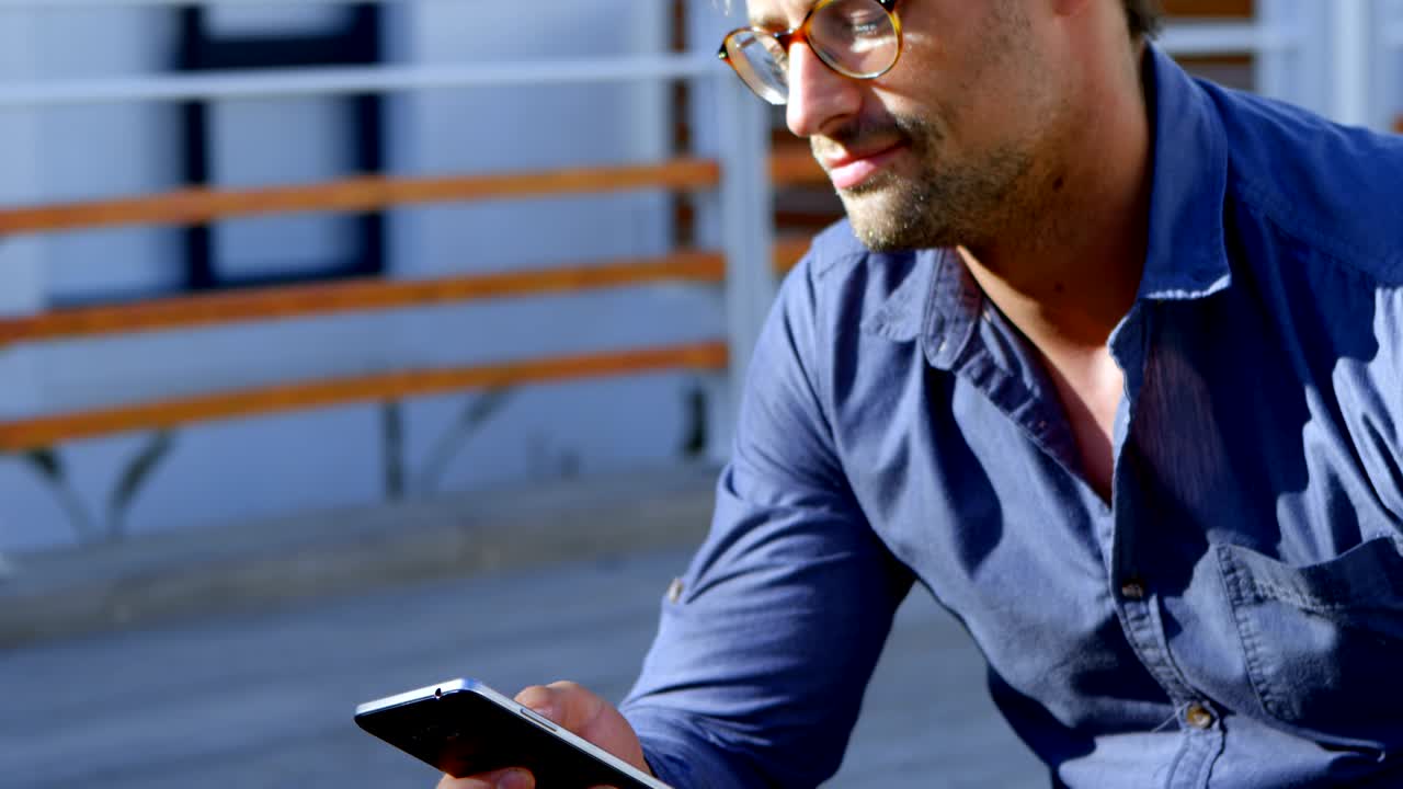 Man using mobile phone in the porch 4k