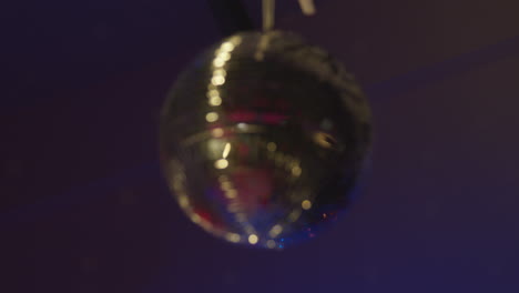 Shot-Of-Defocused-Mirrorball-Slowly-Revolving-In-Night-Club-Or-Disco