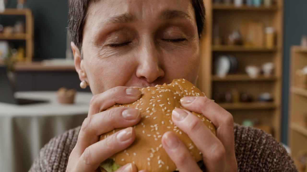 Close-up of an elderly woman reacting to a taste