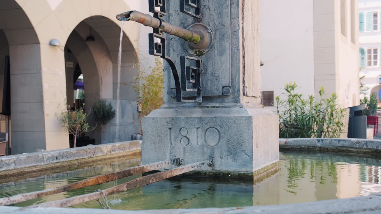 Medium shot of drinking water fountain at Market Place during the day in Nyon, canton of Vaud, Switzerland, outdoor